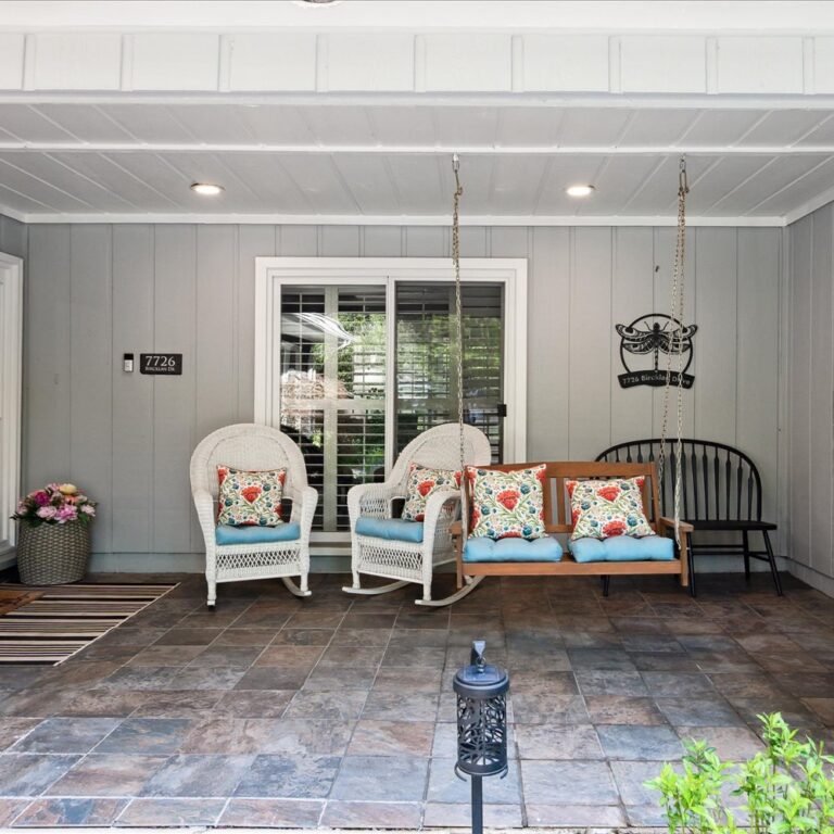 Welcoming and calming front porch at Kendra’s Place assisted living, providing a peaceful outdoor space for residents to enjoy gentle fresh air and familiar home comforts.