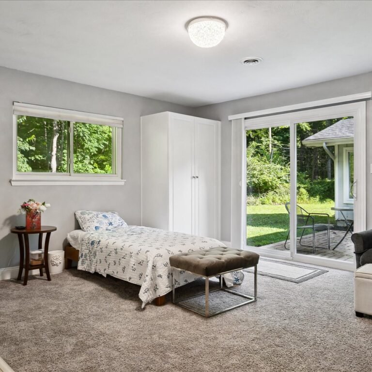 Comfortable and spacious private bedroom with natural light at Kendra’s Place assisted living and memory care in Canton Michigan